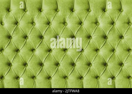 Green capitone checkered soft fabric textile decorative background with buttons. Classic retro Chesterfield style, luxurious upholstery buttoned textu Stock Photo
