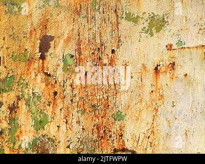 Corroded metal background. Rusted white painted metal wall. Rusty metal background with streaks of rust. Rust stains. The metal surface rusted spots. Stock Photo