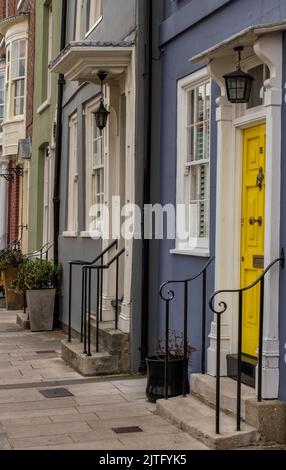 row of colourful front doors on historic houses in old portsmouth uk, terraced houses, period homes, victorian and edwardian homes, georgian houses. Stock Photo