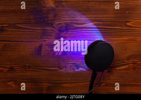 Sunset projector lamp on the table. Multi colored RGB light. Home decor. Copy space Stock Photo