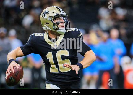 New Orleans Saints quarterback Ian Book (16) is slow to get up aft he was  sacked by Houston Texans defensive tackle Thomas Booker IV (56) during the  second half of an NFL