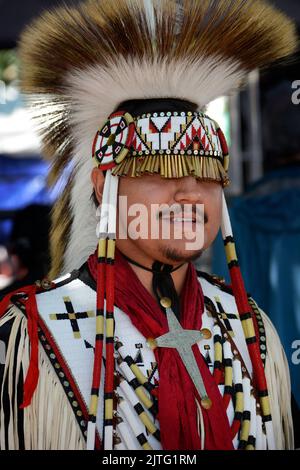 A Native American man, Trae Little Sky, poses for photographs at the annual Santa Fe Indian Market in Santa Fe, New Mexico. Stock Photo