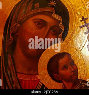 Rheine, NRW, Germany - August 24 2022 Art in the St. Dionysius church. Icon of mother Mary and child Jesus with gold colored background. Detail of the Stock Photo