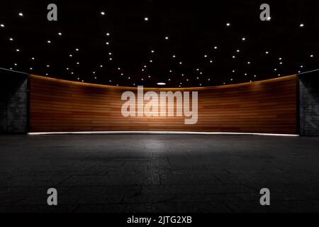 Gray concrete room with wood paneling on the walls and spotlights on the ceiling. Background for product presentation. Stock Photo