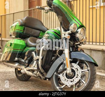 old retro motorcycle traveling through city streets Stock Photo