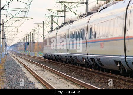 High - speed train sapsan in autumn . An article about high-speed trains. Train Moscow - Saint Petersburg. Lyuban, Russia, October 11, 2021 Stock Photo