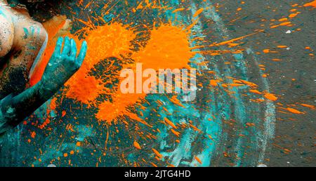 nude woman with body painted with blue body paint smoking at Gay Pride