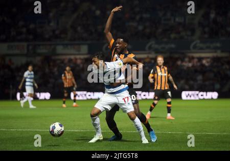 Queens Park Rangers's Andre Dozzell holds off Hull City's Benjamin Tetteh during the Sky Bet Championship match at Loftus Road, London. Picture date: Tuesday August 30, 2022. Stock Photo