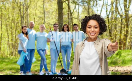 happy volunteer woman pointing finger to camera Stock Photo