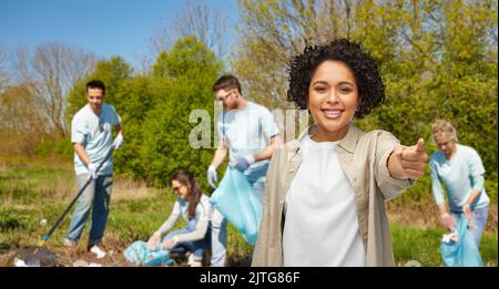 happy volunteer woman pointing finger to camera Stock Photo