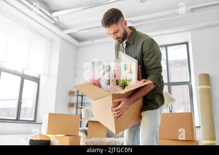 man with boxes moving to new home Stock Photo
