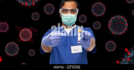 male doctor in mask with blood in test tube Stock Photo