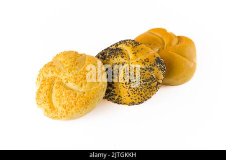 Three fresh kaiser rolls placed in front of each other. Traditional one with no topping, and two alternatives - one with poppy seed topping, and the other with toasted sesame seed topping. Isolated on white background. High quality photo Stock Photo