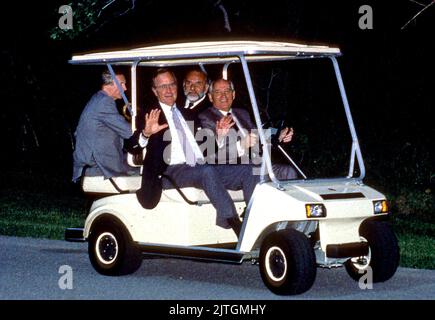 Camp David, Maryland - June 2, 1990 -- United States President George H.W. Bush shows no fear as Soviet President Gorbachev drives a golf cart for the first time at Camp David, Maryland on June 2, 1990.Credit: Ron Sachs/CNP Stock Photo