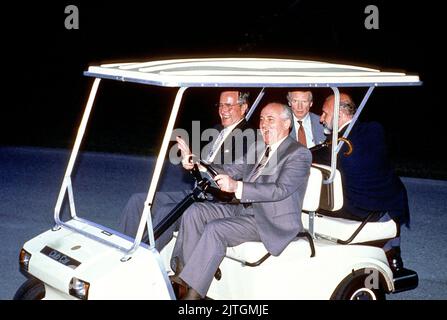 Camp David, Maryland - June 2, 1990 -- United States President George H.W. Bush shows no fear as Soviet President Gorbachev drives a golf cart for the first time at Camp David, Maryland on June 2, 1990.Credit: Ron Sachs/CNP Stock Photo