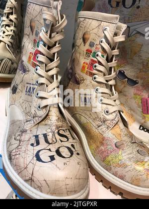 Ladies boots with travel map print and text Stock Photo