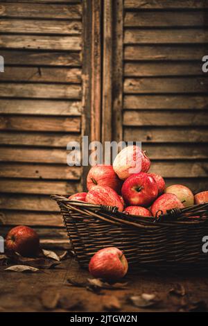 Fresh ripe red appples on a rustic background Stock Photo