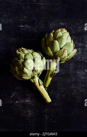 Fresh Artichokes on a black background Stock Photo