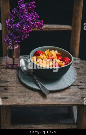 Corn flakes and strawberries in a bowl Stock Photo