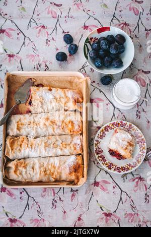Homemade plum strudel in a baking pan Stock Photo