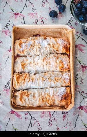 Homemade plum strudel in a baking pan Stock Photo