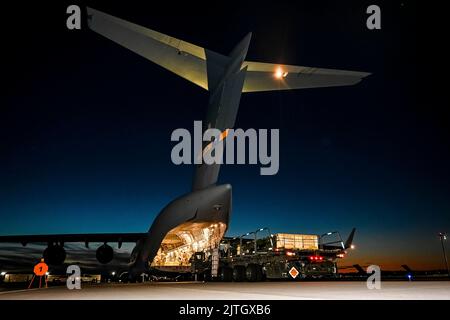 McGuire AFB, New Jersey, USA. 13th Aug, 2022. A C-17 Globemaster III assigned to the Air Mobility Command, prepares to receive the upload of Guided Multiple Launch Rocket System munitions at Joint Base McGuire-Dix-Lakehurst, N.J., Aug. 13, 2022. The munitions cargo is part of an additional security assistance package for Ukraine. The security assistance the U.S. is providing to Ukraine is enabling critical success on the battlefield against the Russian invading force. Credit: U.S. Army/ZUMA Press Wire Service/ZUMAPRESS.com/Alamy Live News Stock Photo