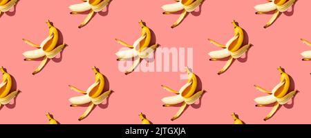 Yellow ripe  bananas on pink background pattern, banner. Minimal style. Flat lay. Stock Photo