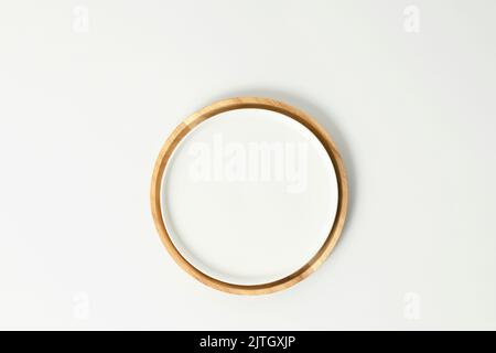 White empty plate on wooden plate flat lay. Provence style, kitchen interior, minimalistic, kinfolk, flat lay Stock Photo
