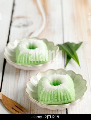 Putu Ayu, Indonesian Traditional Steamed Cup Cake, made from Rice FLour Batter and Shredded Coconut with Pandan Leaf Aromatic, Selective Focus Stock Photo