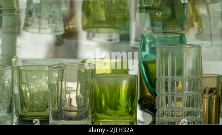 Closeup of assortment of green, brown ,white glasses on a shelf Stock Photo