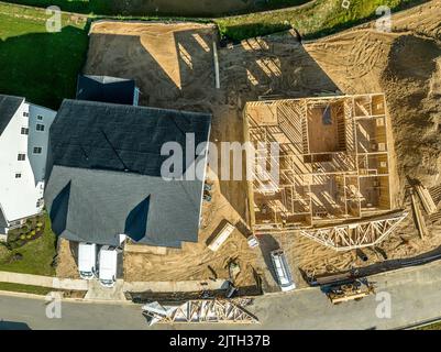 Wooden formwork of an unfinished house next to a move in ready home Stock Photo