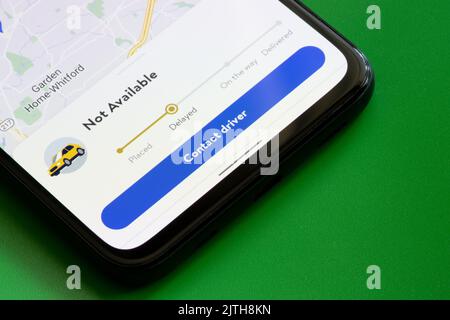 Delivery tracking page in the Walmart mobile app, which shows that the delivery is delayed, is seen on the screen of a smartphone. Stock Photo