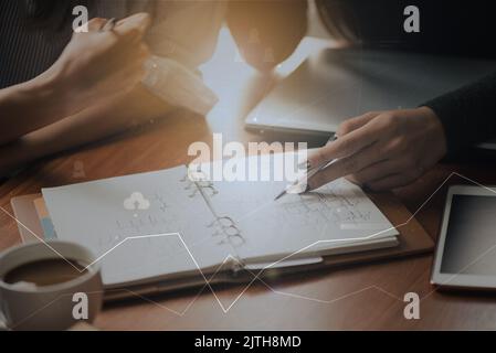Team work process. young business managers crew working with new startup project. laptop on wood table, typing keyboard, analyse graph Stock Photo