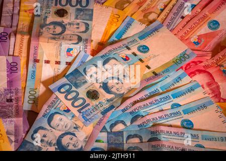 Philippine peso bills, 50, 100, 500 and 1000 pesos, money cash fiat papers. Economy and financial concept, currency denominations Stock Photo