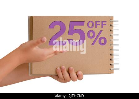 25 percent discount on isolate. Notepad from recycled paper in the hands of a child with text, sale up to 25 percent. The child is holding a notepad Stock Photo
