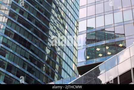 Selective focus Modern architecture. Several Hi-tech office buildings fragment. Abstract glass background, eco-friendly technologies concept. Modern c Stock Photo