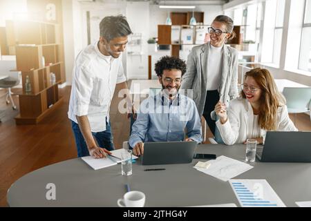 Happy coworkers cooperating and working together at office meeting, teamwork concept Stock Photo