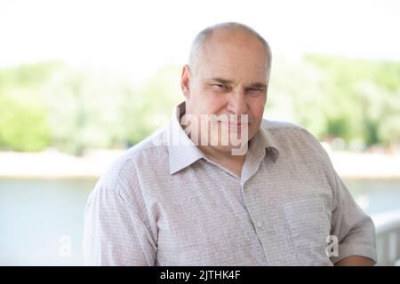 Portrait of an elderly man of European appearance. He looks into the camera. Stock Photo