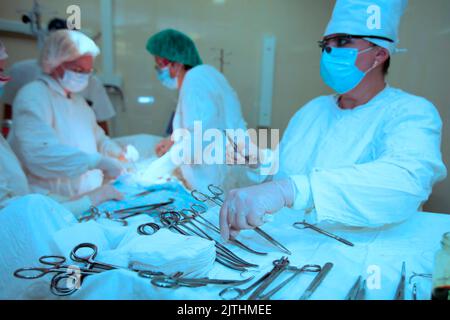 Surgeons during the operation. Professional doctors performing surgeries. Stock Photo