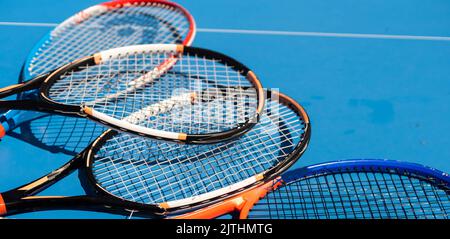 broken tennis rackets on clay tennis court Stock Photo