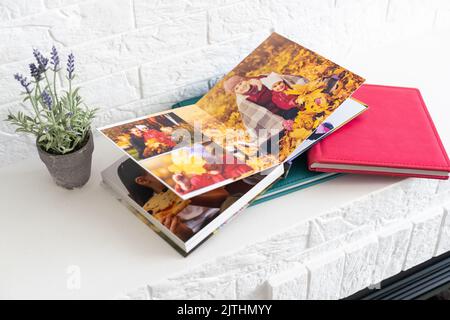 photo book with leather cover. Stylish photo album. Family photoalbum on the white table. Beautiful notepad or photobook with elegant openwork Stock Photo