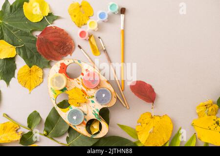 Children's picture made from autumn leaves with pencil drawing on paper Stock Photo