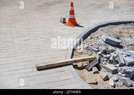 Pavement repair and laying of paving slabs on the walkway, stacked tile cubes on the background. Laying paving slabs in the pedestrian zone of the Stock Photo