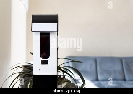 Close-up detail of smart automatic touchless hand sensor sanitizer disinfectant spray dispenser machine device office entrance, hospital or shopping Stock Photo