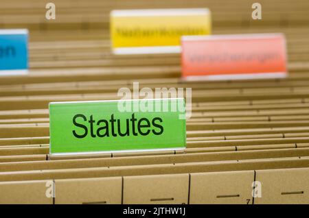 Hanging file folder labeled with Satutes Stock Photo