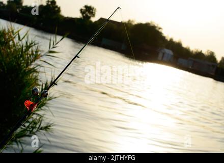Fishing rod bell, on fishing line with beach background, sunrise time Stock  Photo - Alamy