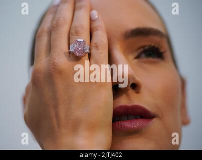 Model Nina Uhl wearing a large, pure pink, diamond on display at Sotheby's, central London, before it is offered at auction this autumn, when it is estimated to fetch in excess of USD 21million. The last time a gem of this colour, quality and size was shown to the world was in 2017 and it went on to become the world's most expensive diamond, and the most expensive gemstone ever to be sold at auction. This new stone has the potential to achieve a higher price per carat. Picture date: Wednesday August 31, 2022. Stock Photo