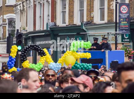 London, UK. 29th August 2022. Police officers observe the crowds on the second day as Notting Hill Carnival returns after a two-year absence. Stock Photo