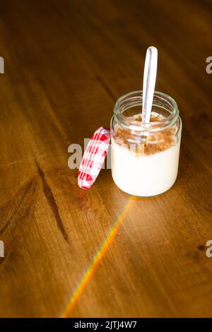 Homemade rice pudding in a glass pot on a wooden table Stock Photo