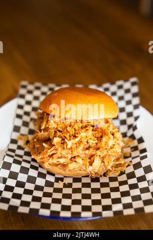Pulled chicken burger on a wooden table Stock Photo